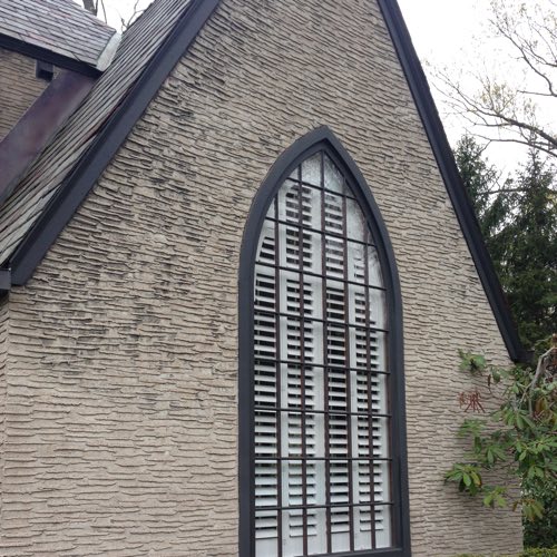 outside view of brick home with plantation shutters